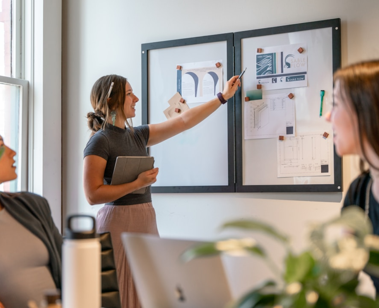 Woman presenting at whiteboard